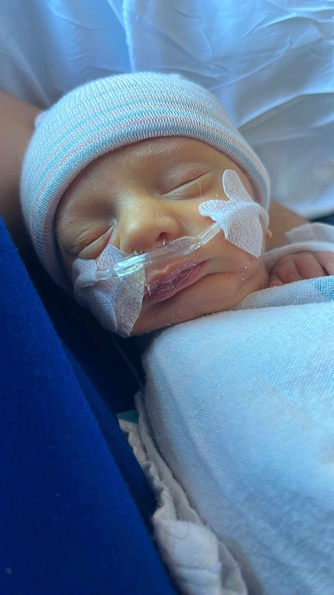 Silas is registered to the contest to win money with this photo: newborn, baby, infant, sleeping, hat, blanket, nasal_tube, medical, closeup, face, skin, person, peaceful, resting, healthcare, hospital, cute, tiny, child, wrapped