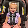 Oaklynn is registered to the contest to win money with this photo: baby, car_seat, casual_clothing, child, cute, floor, happy, headband, indoor, infant, person, pink_headband, pink_pants, purple_shirt, safety_harness, seatbelt, small_child, smiling, warning_label, white_socks