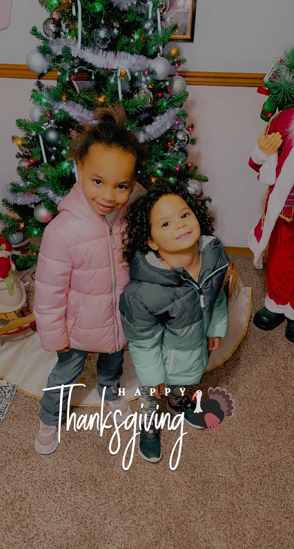 Yazmyne joined the competition — help win amazing prizes! baby_toddler_clothing, child, christmas_decoration, christmas_ornament, christmas_tree, event, face, facial_expression, fun, green, happy, holiday, holiday_ornament, human_body, joy, ornament, outerwear, person, smile, standing