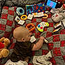 baby, blanket, book, cartoon, child, colorful, crawling, diaper, fabric, floor, hand, indoor, infant, person, playing, plush_toys, quilt, soft_toys, tablet, toys