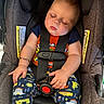 Wilson is registered to the contest to win money with this photo: baby, bracelet, car_seat, child, clothing, cute, face, hand, head, indoor, infant, pajamas, patterned_clothing, peaceful, person, rest, safety, seatbelt, sleeping, toddler