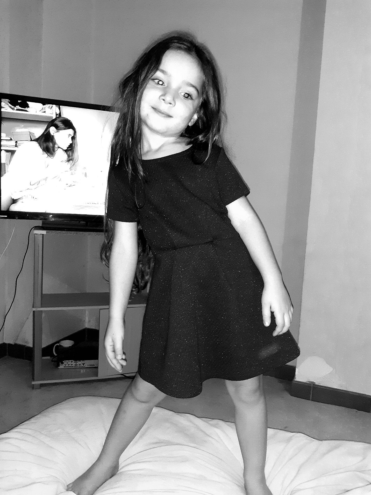 Wendy participe au concours pour gagner de l'argent avec cette photo : black, black_and_white, clothing, dress, human_body, human_leg, joint, joy, knee, leg, little_black_dress, long_hair, monochrome, monochrome_photography, person, room, shoulder, sitting, smile, standing