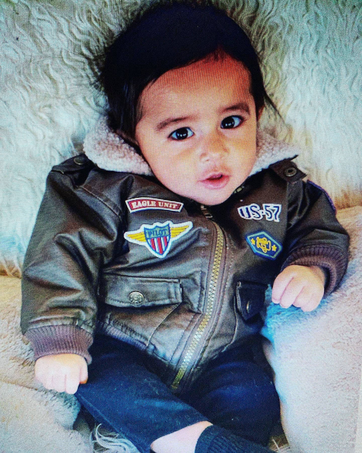 Jiovanni is registered to the contest to win money with this photo: baby_toddler_clothing, brown_hair, cheek, child, cool, electric_blue, flash_photography, fun, fur, happy, head, iris, jacket, lip, nose, outerwear, person, sitting, skin, sleeve