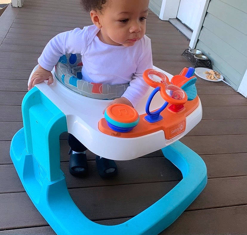 Knox is registered to the contest to win money with this photo: baby, baby_playing_with_toys, baby_toddler_clothing, blue, child, electric_blue, fun, happy, headwear, leisure, person, plastic, play, recreation, riding_toy, sharing, sitting, tire, toddler, toy
