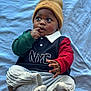 Drayson is registered to the contest to win money with this photo: baby, infant, beanie, hat, finger_in_mouth, laying_down, blanket, portrait, onesie, long_sleeve, red_sleeve, green_sleeve, socks, comfy_pants, toddler_clothing, nyc_logo, curious_gaze, big_eyes, soft_light, indoor