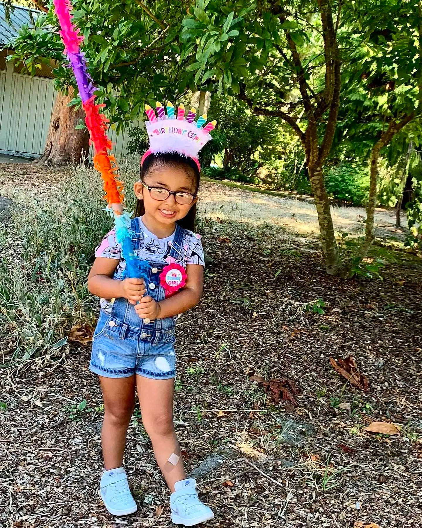 Saige joined the competition — help win amazing prizes! botany, clothing, electric_blue, grass, happy, human_leg, joy, leaf, leg, leisure, people_in_nature, person, pink, plant, recreation, shorts, smile, thigh, toddler, tree