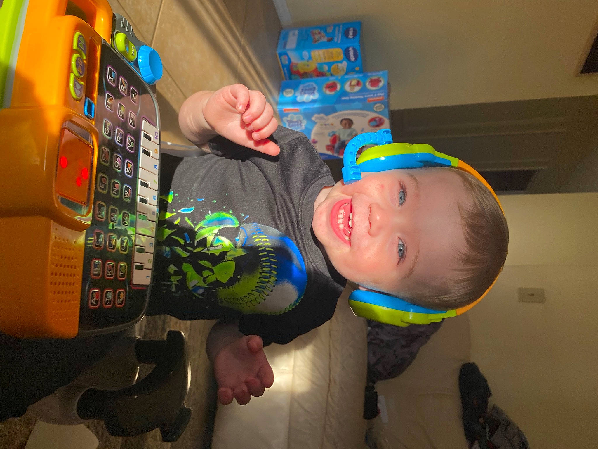 Maximus is registered to the contest to win money with this photo: baby, baby_laughing, baby_products, baby_toddler_clothing, bottle, carbonated_soft_drinks, child, drink, fun, happy, machine, person, personal_protective_equipment, plastic, plastic_bottle, play, room, smile, toddler, toy
