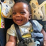 Milo is registered to the contest to win money with this photo: baby, infant, child, smiling, happy, face, portrait, car_seat, seatbelt, buckled, vehicle, snoopy, shirt, short_sleeves, cushion, patterned, indoor, close_up,  안전, photography