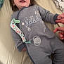baby, bed, blanket, child, clothing, cute, finger, hair, hand, happy, human, indoor, infant, infant_toys, lying_down, onesie, pacifier, person, sleepwear, smiling