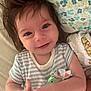Henry is registered to the contest to win money with this photo: arm, baby, blanket, child, closeup, cute, face, hair, happy, indoors, infant, lying_down, pacifier_clip, pattern, person, portrait, skin, smile, striped_clothing, young