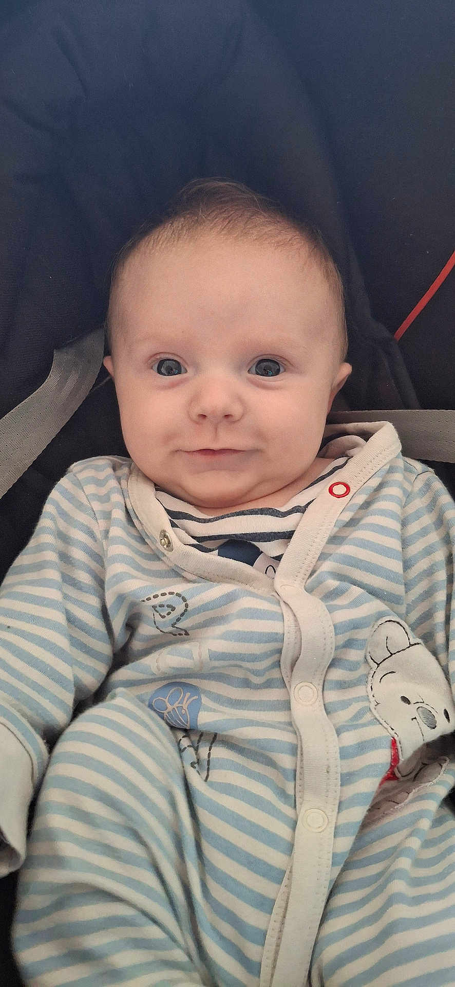 Noha participe au concours pour gagner de l'argent avec cette photo : baby, infant, child, onesie, striped_clothing, cute, portrait, face, eyes, smile, sitting, soft_lighting, indoor, cozy, clothing, person, young_child, comfort, babywear, closeup