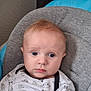baby, baby_chair, blue_eyes, casual_wear, child, closeup, clothing, comfort, cute, expression, face, indoor, infant, mustard_pants, patterned_shirt, portrait, seated, smiling_clouds, soft_fabric, young_child