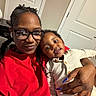 Daqariah joined the competition — help win amazing prizes! woman, child, toddler, glasses, red_clothing, cream_clothing, indoor, door, hand, nails, smile, portrait, family, casual, closeup, happy, person, home, seated, cute