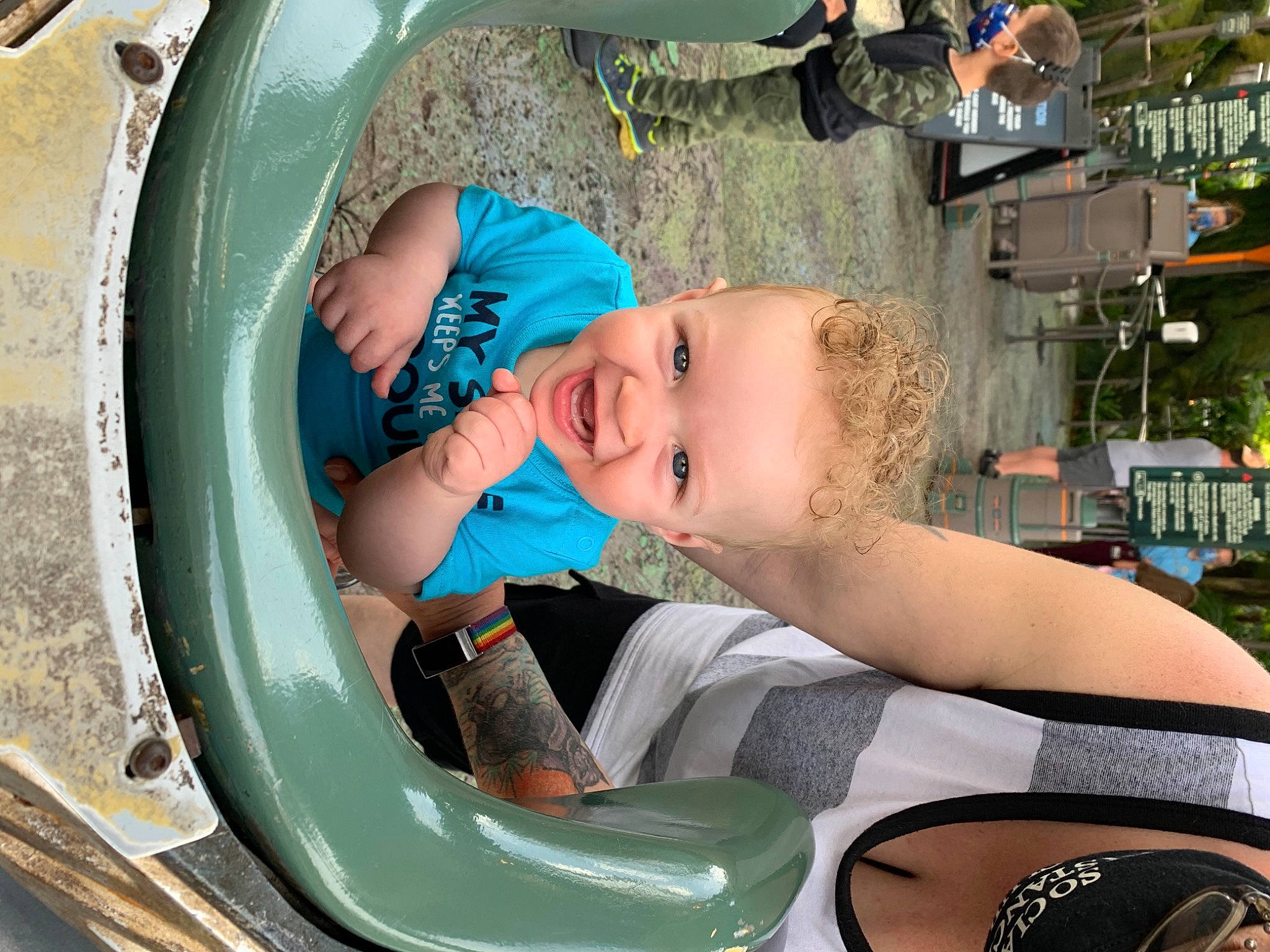 Jaylin is registered to the contest to win money with this photo: auto_part, automotive_exterior, automotive_tire, baby, baby_products, bumper, chest, child, circle, eyewear, fun, green, hat, leisure, person, plant, recreation, sitting, smile, toddler