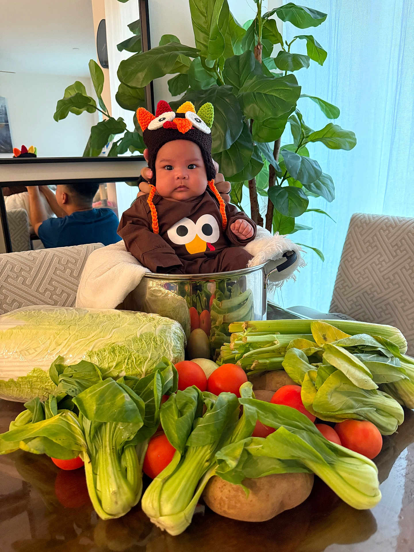 Andy is registered to the contest to win money with this photo: baby, child, clothing, cute, face, food, fresh, funny, greenery, hat, indoor, lettuce, mirror, person, plant, pot, reflection, table, tomatoes, vegetables