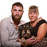 Momo participe au concours pour gagner de l'argent avec cette photo : beard, black_top, couple, cuddling, dog, family, hands, happy, leopard_print, man, pet, portrait, scruffy_dog, sitting, smiling, striped_shirt, studio, white_background, wirehaired_dog, woman