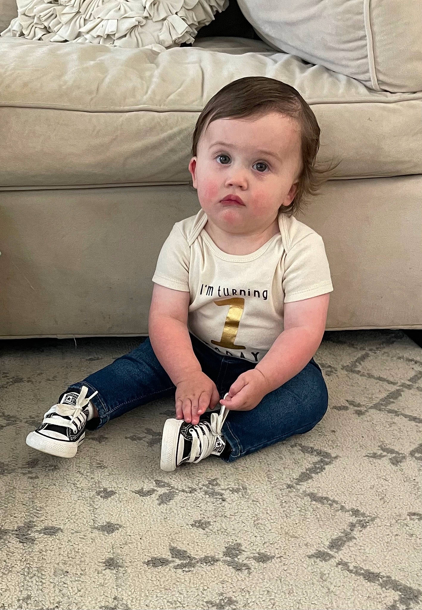 River is registered to the contest to win money with this photo: baby, baby_toddler_clothing, child, comfort, couch, flash_photography, floor, flooring, foot, fun, grass, happy, human_leg, knee, pattern, person, portrait_photography, shoe, sitting, surprise