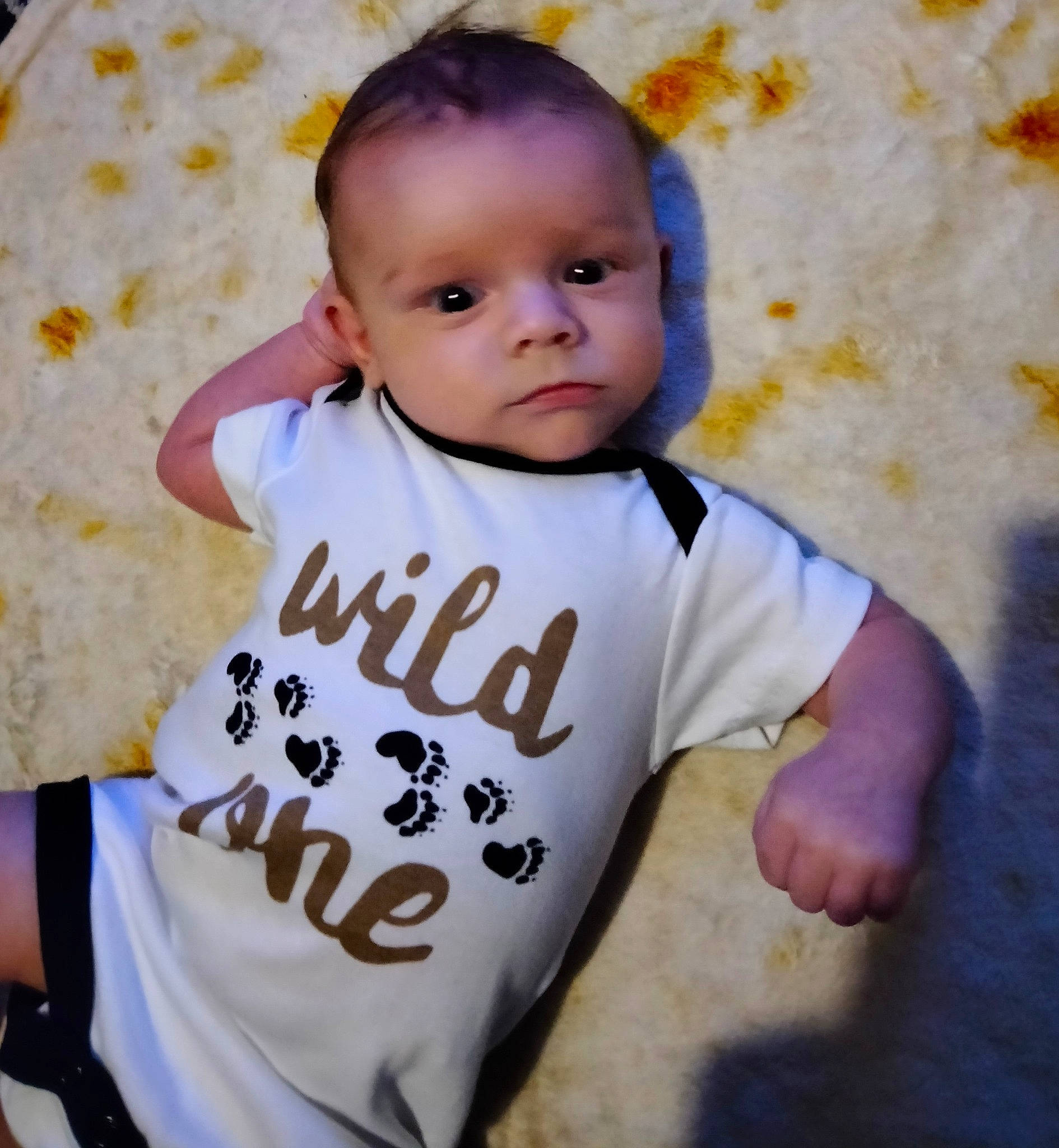 Lucian is registered to the contest to win money with this photo: arm, baby, baby_toddler_clothing, cheek, cool, eyebrow, finger, gesture, happy, human_body, jersey, mammal, neck, nose, person, skin, sleeve, smile, t_shirt, textile