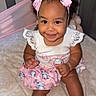 baby, child, smiling, headband, pink, skirt, elephant_print, footwear, crib, bed, cute, happy, infant, lace, sitting, indoors, portrait, childrens_clothing, accessories, playful