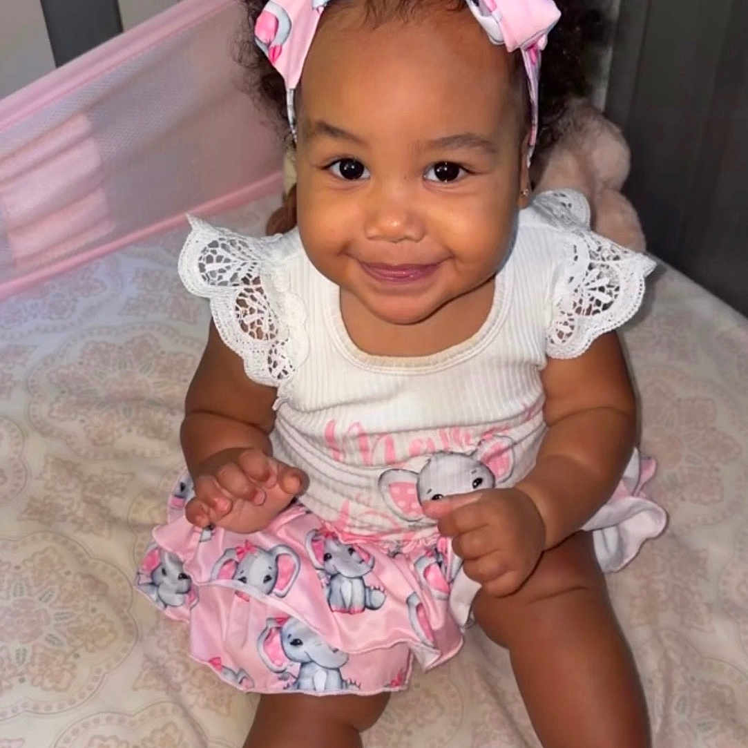 Jadore joined the competition — help win amazing prizes! baby, child, smiling, headband, pink, skirt, elephant_print, footwear, crib, bed, cute, happy, infant, lace, sitting, indoors, portrait, childrens_clothing, accessories, playful