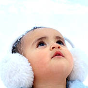 Pearl is registered to the contest to win money with this photo: baby, child, face, earmuffs, winter, snow, cold, portrait, closeup, fluffy, cute, looking_up, headwear, outdoor, skin, eyelashes, winter_clothing, young, innocent, soft