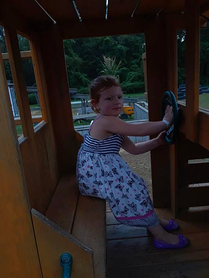 Ashleigh is registered to the contest to win money with this photo: arm, blue, child, clothing, day, dress, fun, girl, house, lighting, person, play, product, recreation, sitting, standing, toddler, vacation, window