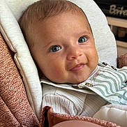Alba participe au concours pour gagner de l'argent avec cette photo : baby, infant, face, eyes, smile, clothing, striped, seat, cushion, fabric, portrait, closeup, child, cute, expression, skin, head, indoor, person, young