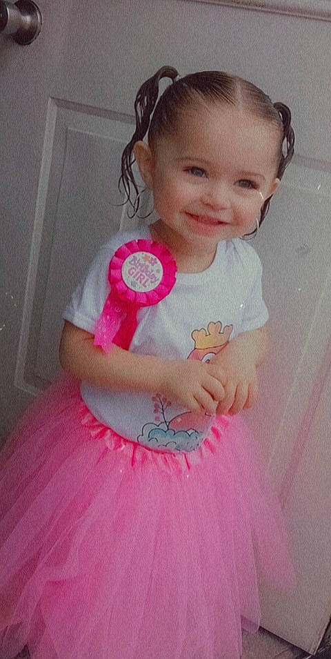 Alivia is registered to the contest to win money with this photo: baby_toddler_clothing, cheek, clothing, day_dress, dress, embellishment, eyelash, face, facial_expression, hair, happy, head, iris, joy, person, pink, shoulder, skin, sleeve, smile