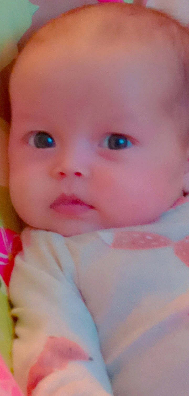 Abriella is registered to the contest to win money with this photo: baby, baby_toddler_clothing, cheek, child, chin, dress, eye, eyebrow, eyelash, happy, iris, lip, nail, nose, peach, person, pink, portrait_photography, skin, thumb