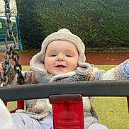 Theodore joined the competition — help win amazing prizes! baby, cap, clothing, coat, face, grass, hat, head, jacket, nature, outdoorplayarea, outdoors, park, person, photography, plant, playarea, portrait, swing, toy