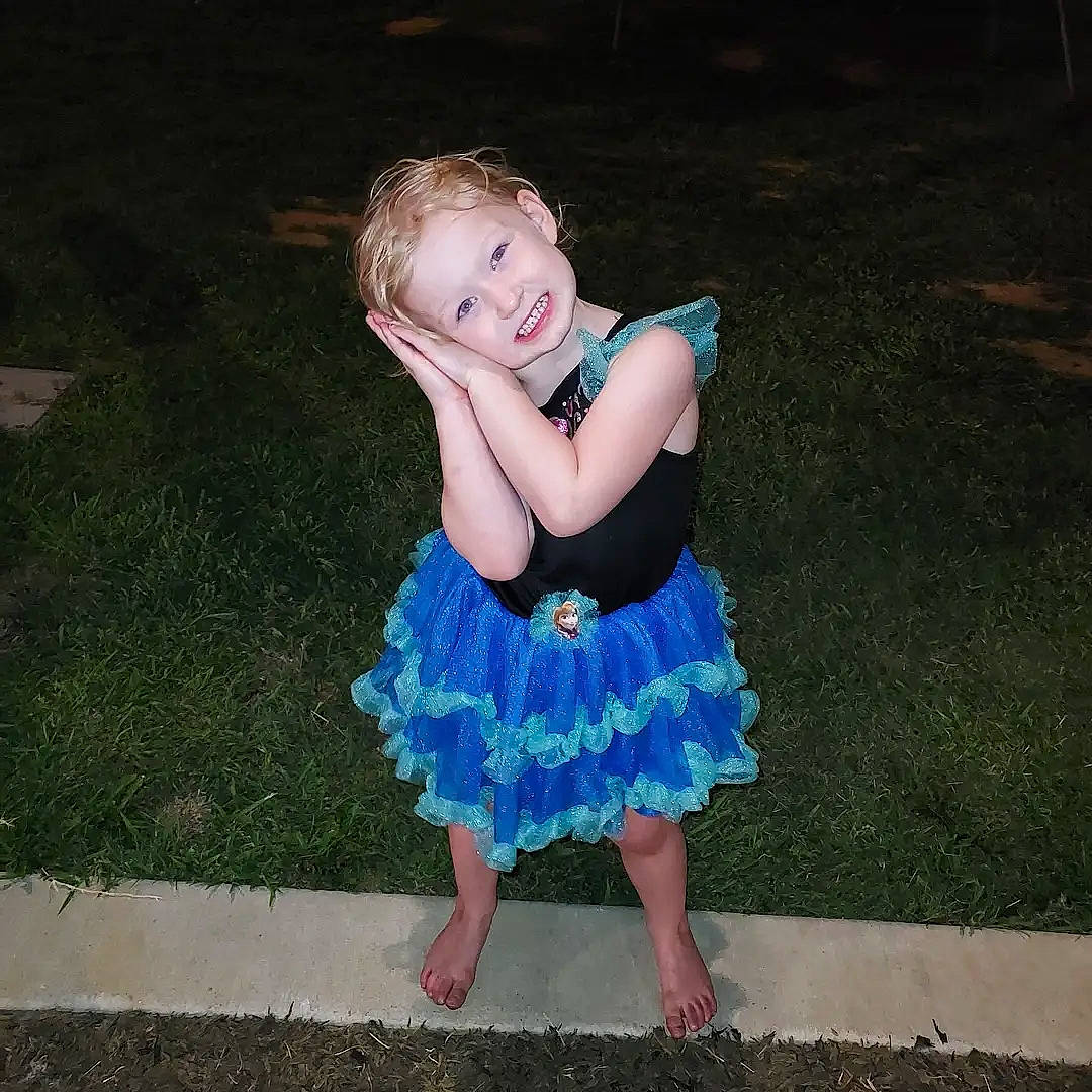 Aurora is registered to the contest to win money with this photo: baby, baby_toddler_clothing, day_dress, dress, electric_blue, event, face, fun, grass, hair, happy, head, human_leg, joy, one_piece_garment, pattern, people_in_nature, person, sleeve, smile