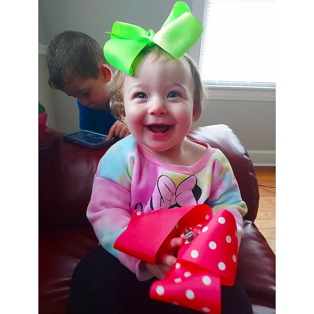 Veronica is registered to the contest to win money with this photo: baby, baby_toddler_clothing, cap, child, comfort, costume_hat, event, fashion_accessory, happy, head, headgear, human_body, joy, magenta, outerwear, person, pink, product, sleeve, smile