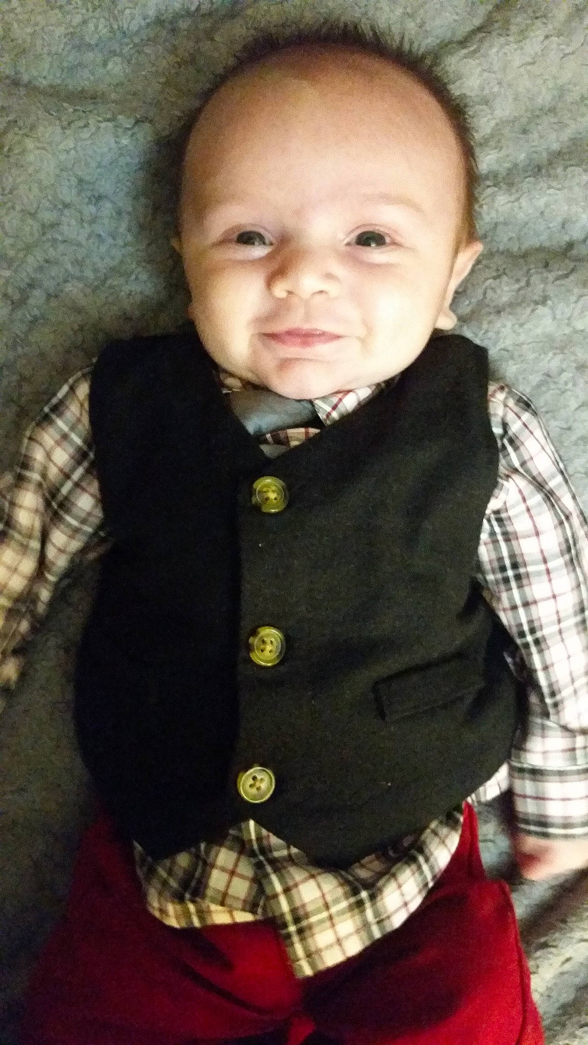 Rowan is registered to the contest to win money with this photo: baby, cheek, child, design, outerwear, pattern, person, plaid, smile, tartan, textile, toddler