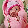 Kimberly is registered to the contest to win money with this photo: baby, pacifier, pink_clothing, hat, blanket, beaded_clip, indoor, closeup, cute, infant, soft_texture, warm, toddler, child, face, headwear, comfort, resting, wrapped, person
