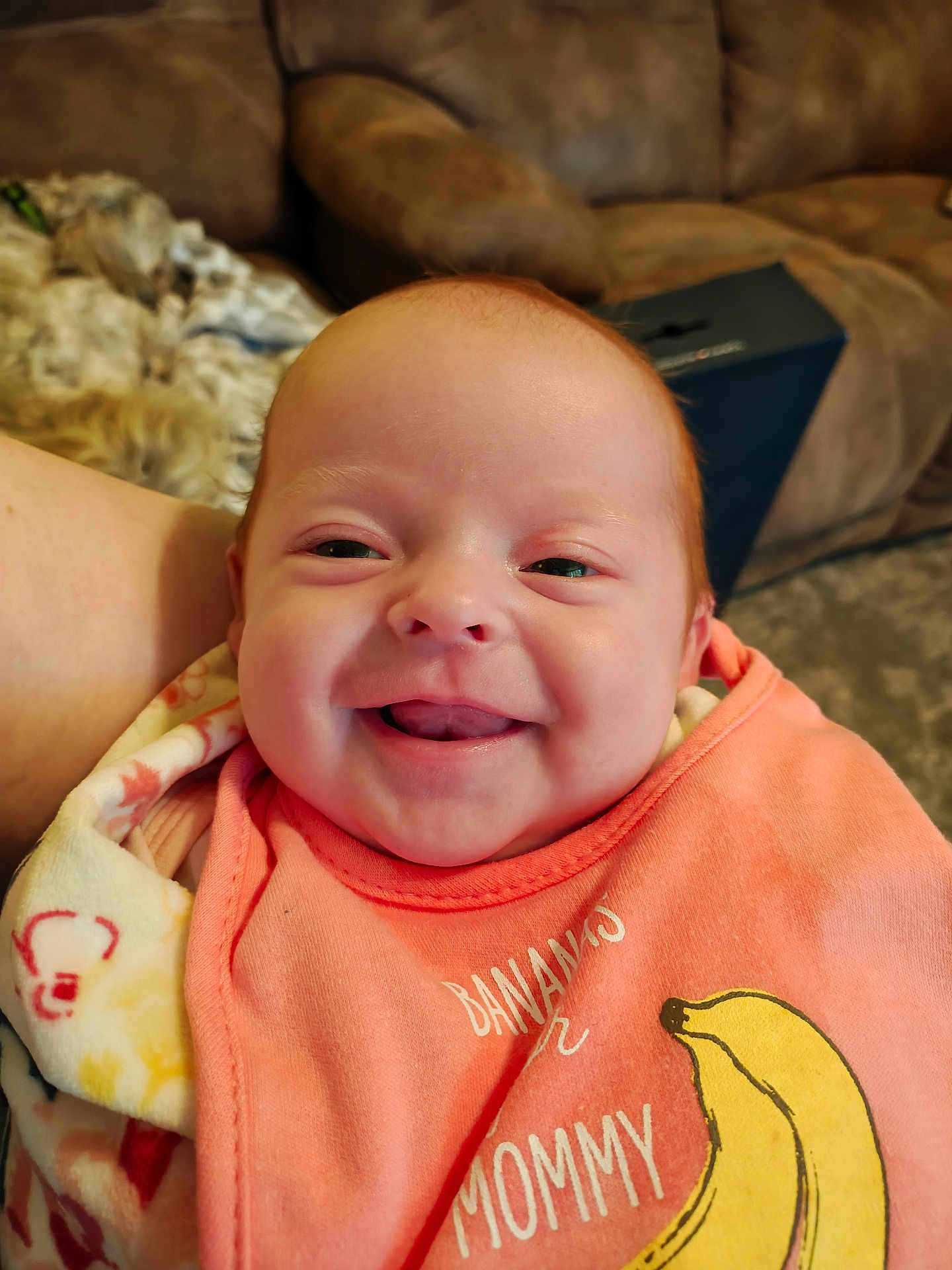 Kimberly joined the competition — help win amazing prizes! baby, smiling, infant, bib, blanket, indoor, person, face, happy, couch, clothing, head, closeup, child, comfort, relaxation, orange, yellow, cute, portrait