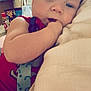 Phoenix joined the competition — help win amazing prizes! baby, infant, child, face, hand, pillow, red_clothing, indoor, kitchen, furniture, person, cute, resting, sucking_fingers, closeup, soft_lighting, background, home, comfort, young