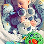 baby, sleeping, plush_toy, cow, blanket, pacifier, toy, infant, child, soft, comfort, cute, hand, face, peaceful, indoors, closeup, cozy, resting, soft_toys