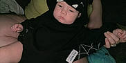 Phoenix is registered to the contest to win money with this photo: baby, bat_ears, black_clothing, casual, child, comfort, cute, hand, holding, hoodie, indoors, infant, lap, person, plush_toy, resting, skin, sleepy, soft_toy, toddler