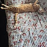 animal, cat, comfortable, cozy, cute, domestic_cat, feline, floral_pattern, furniture, ginger_cat, home, indoor, laying_down, pet, quilted_couch, relaxed, resting, stretching, sunlit, tabby