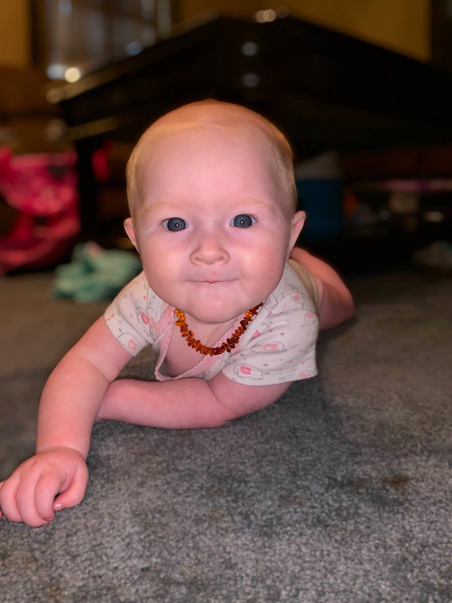 Isabella is registered to the contest to win money with this photo: baby, cheek, child, chin, crawling, eye, face, floor, flooring, fun, head, iris, lip, person, pink, sitting, skin, smile, toddler, vacation