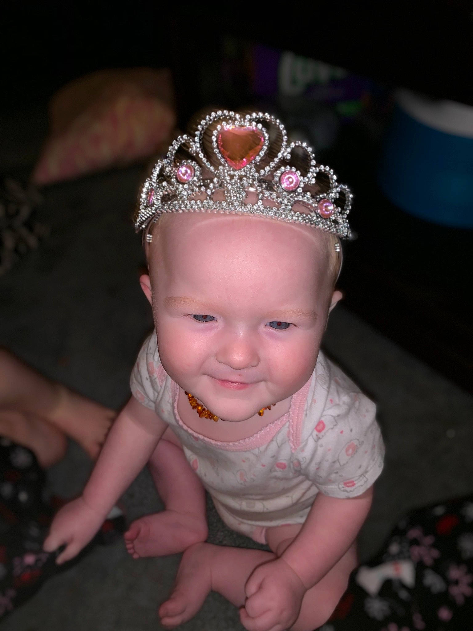 Isabella is registered to the contest to win money with this photo: baby, cheek, child, crown, fashion_accessory, forehead, fun, hair_accessory, head, headband, headgear, headpiece, jewellery, person, pink, sitting, smile, tiara, toddler