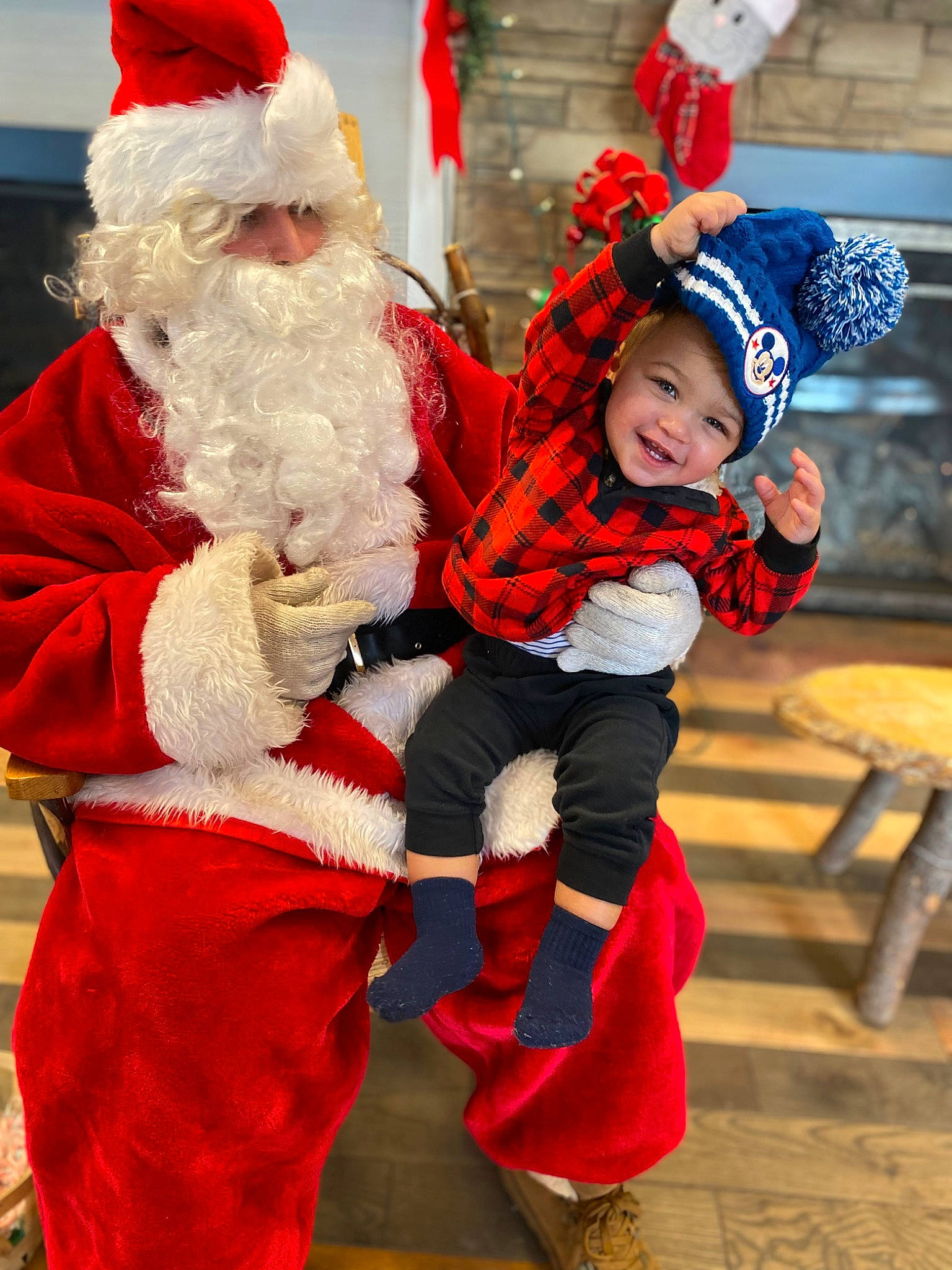 Jeremiah is registered to the contest to win money with this photo: beard, child, christmas, christmas_eve, costume_hat, event, fictional_character, fun, glove, happy, hat, headwear, holiday, lap, person, plant, red, santa_claus, smile, toddler