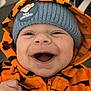 baby, child, smiling, hoodie, orange, tiger_stripes, beanie, lion_king, hat, cute, happy, indoor, clothing, person, face, portrait, infant, joyful, expression, fashion