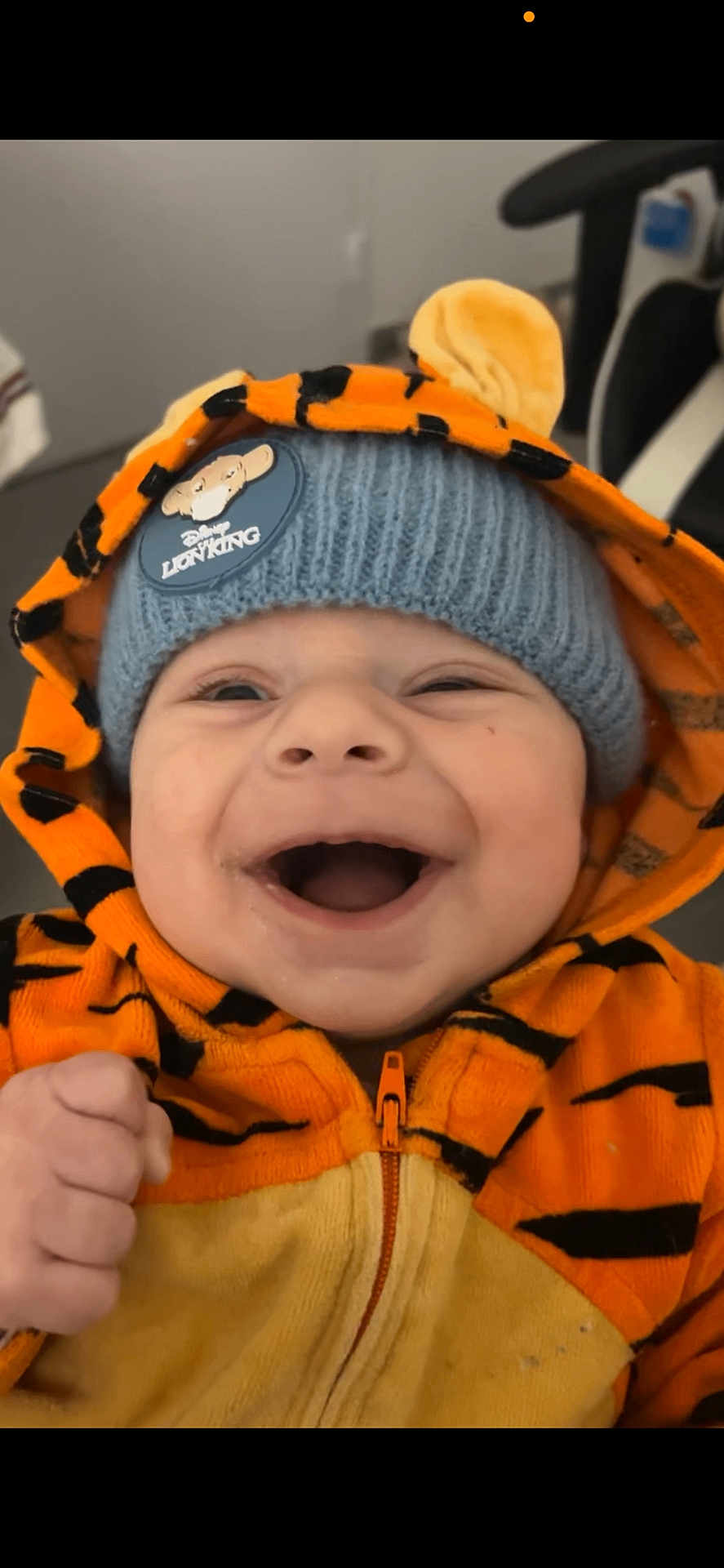 Emilio participe au concours pour gagner de l'argent avec cette photo : baby, child, smiling, hoodie, orange, tiger_stripes, beanie, lion_king, hat, cute, happy, indoor, clothing, person, face, portrait, infant, joyful, expression, fashion