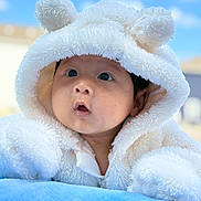 Justin is registered to the contest to win money with this photo: baby, infant, hoodie, white, fluffy, soft, blue_blanket, outdoor, sky, clouds, cute, face, expression, child, portrait, warm_clothing, adorable, young, curious, resting
