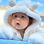 baby, infant, hoodie, white, fluffy, soft, blue_blanket, outdoor, sky, clouds, cute, face, expression, child, portrait, warm_clothing, adorable, young, curious, resting