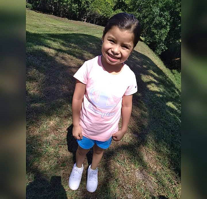 Jennifer is registered to the contest to win money with this photo: arm, baby_toddler_clothing, facial_expression, flash_photography, footwear, gesture, grass, happy, human, joy, leg, mammal, natural_environment, people_in_nature, person, plant, product, shorts, sleeve, smile