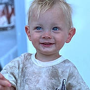 Ardie is registered to the contest to win money with this photo: child, toddler, boy, blond_hair, blue_eyes, smile, shirt, cactus_print, dirty_clothes, portrait, face, happy, cute, young_child, casual_clothing, indoor, person, expression, light_background, small_child
