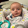 John Lee joined the competition — help win amazing prizes! baby, child, infant, face, eyes, expression, seat, toy, plastic, pillow, blanket, clothing, pattern, indoor, person, smile, cute, young, head, babygear
