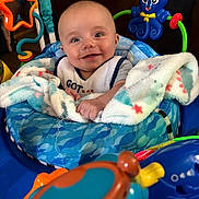 John Lee joined the competition — help win amazing prizes! baby, blanket, blue, child, clothing, face, happy, indoor, octopus_toy, play_center, plastic_toy, smile, star_mirror, toy, toddler, wrapped, infant, seat, colorful, hands